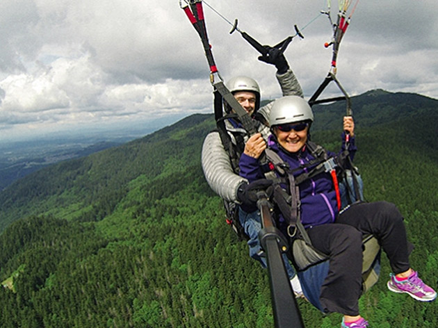 couple having fun paragliding